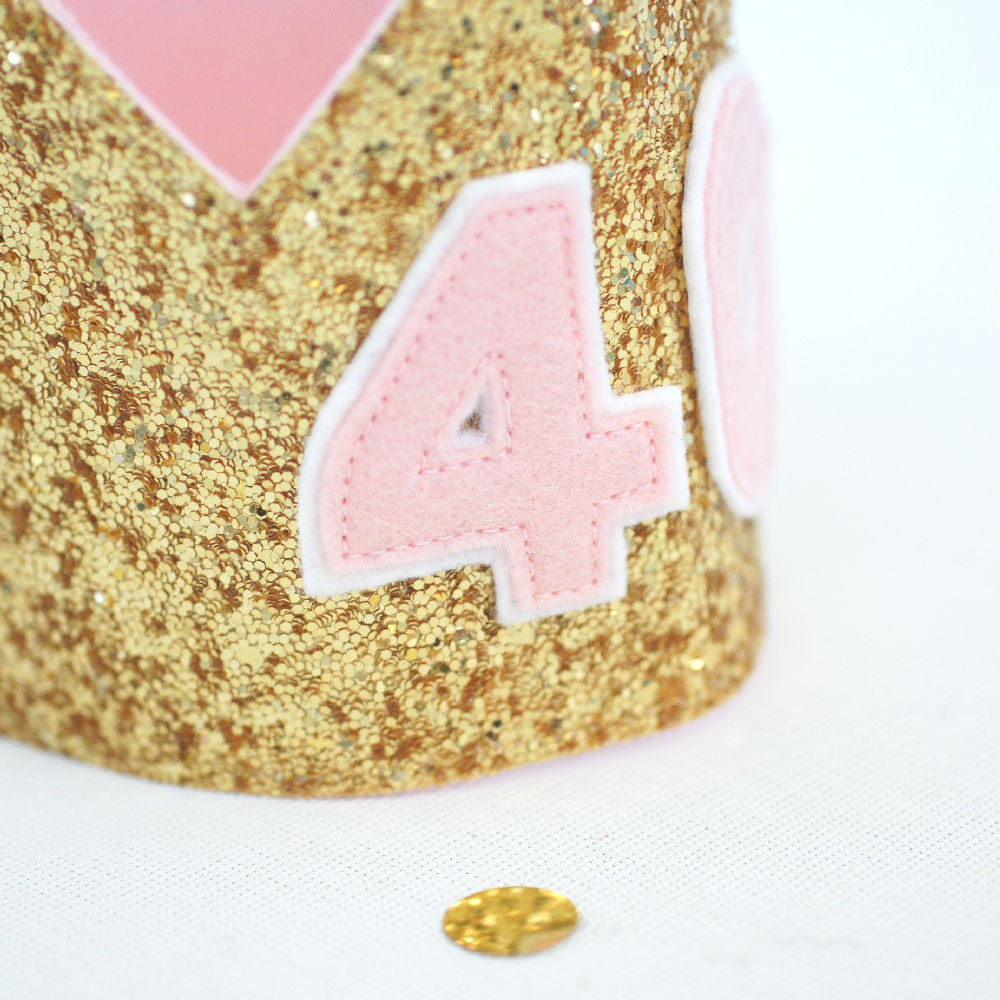 close up view of the number 40 cut from pale pink felt stitched onto golf glitter fabric to create a 40th birthday crown