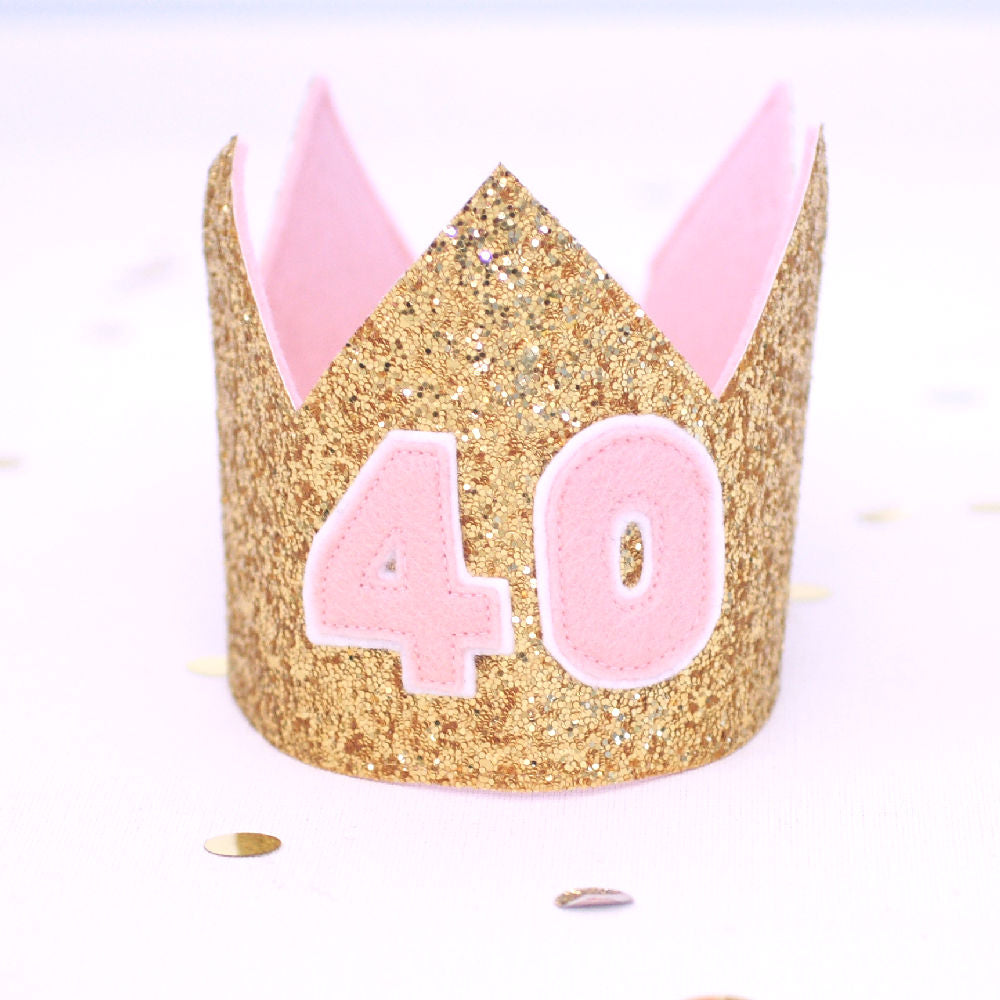 front view of a gold glitter and pale pink felt 40th birthday crown